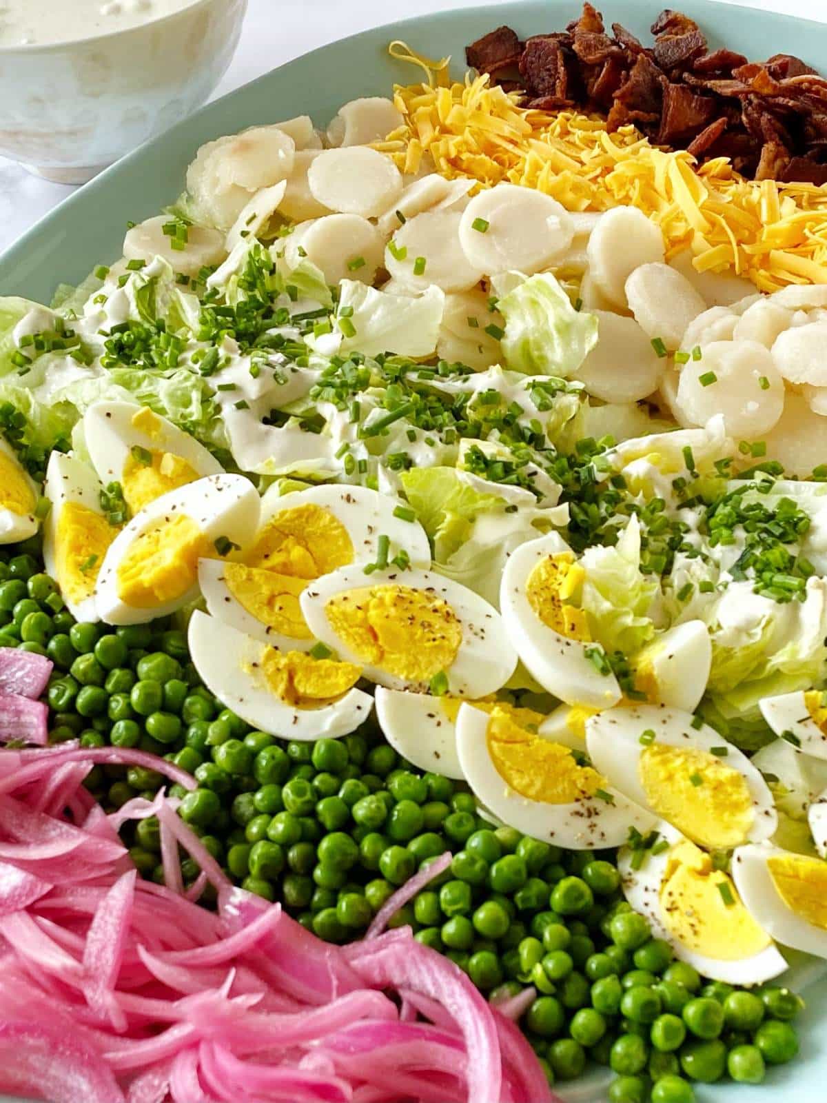 Salad ingredients layered on a serving platter.