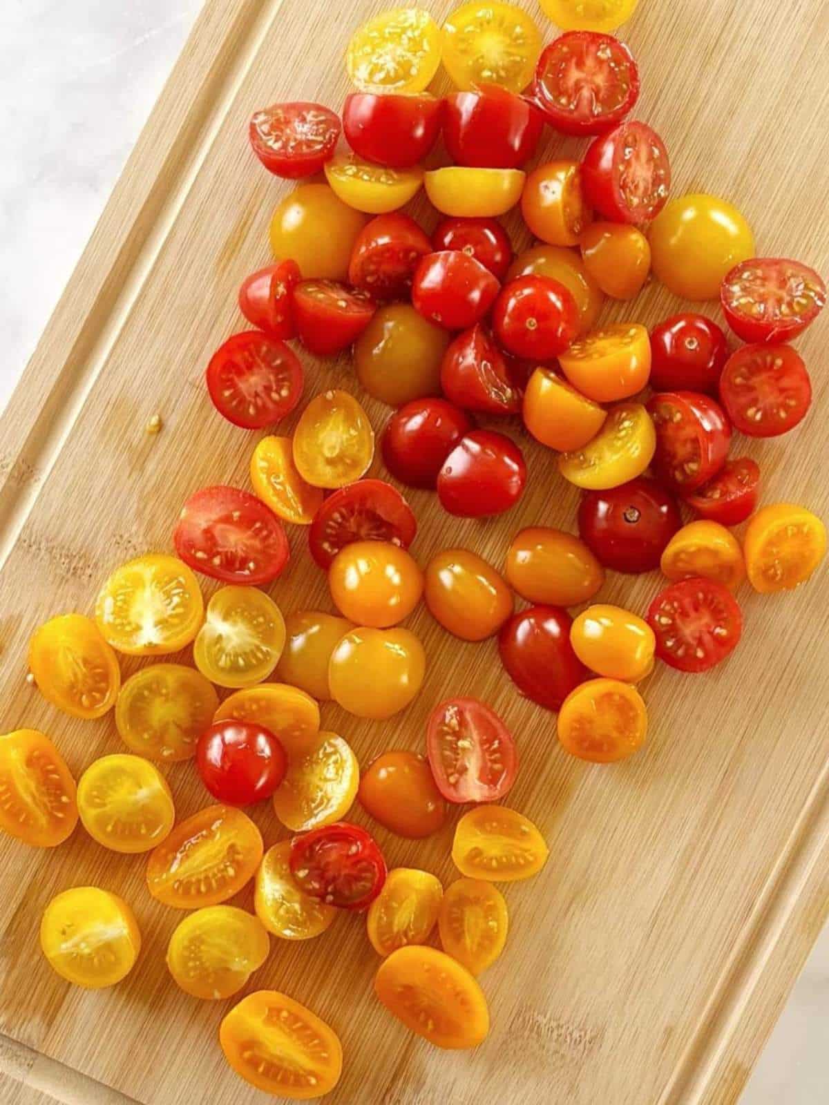 Halved tomatoes on a cutting board.