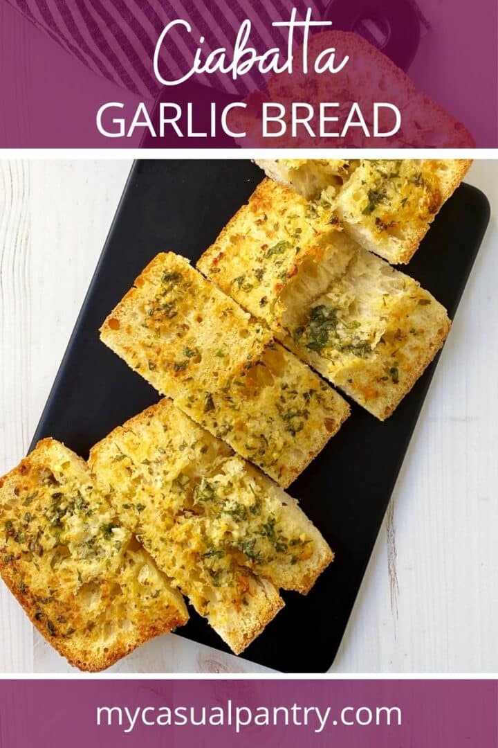 Sliced garlic bread on a serving board.