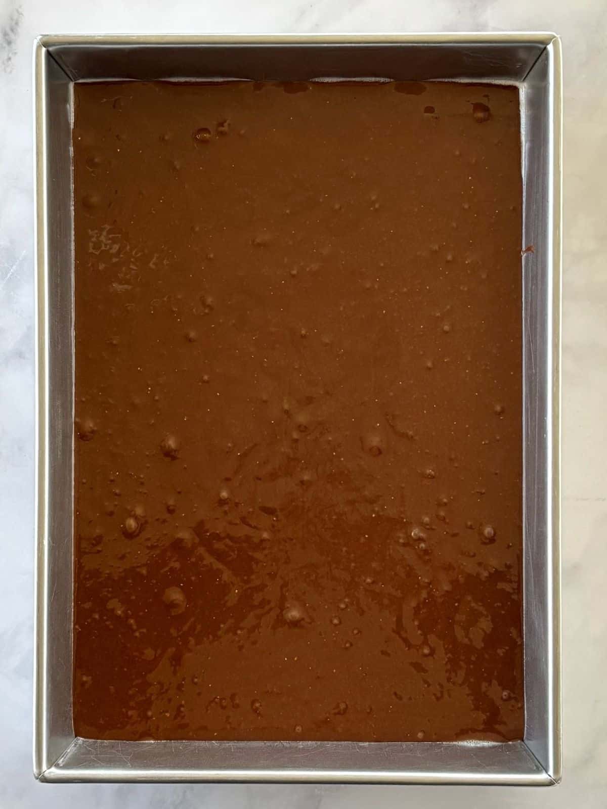 Cake batter in a rectangular cake pan.