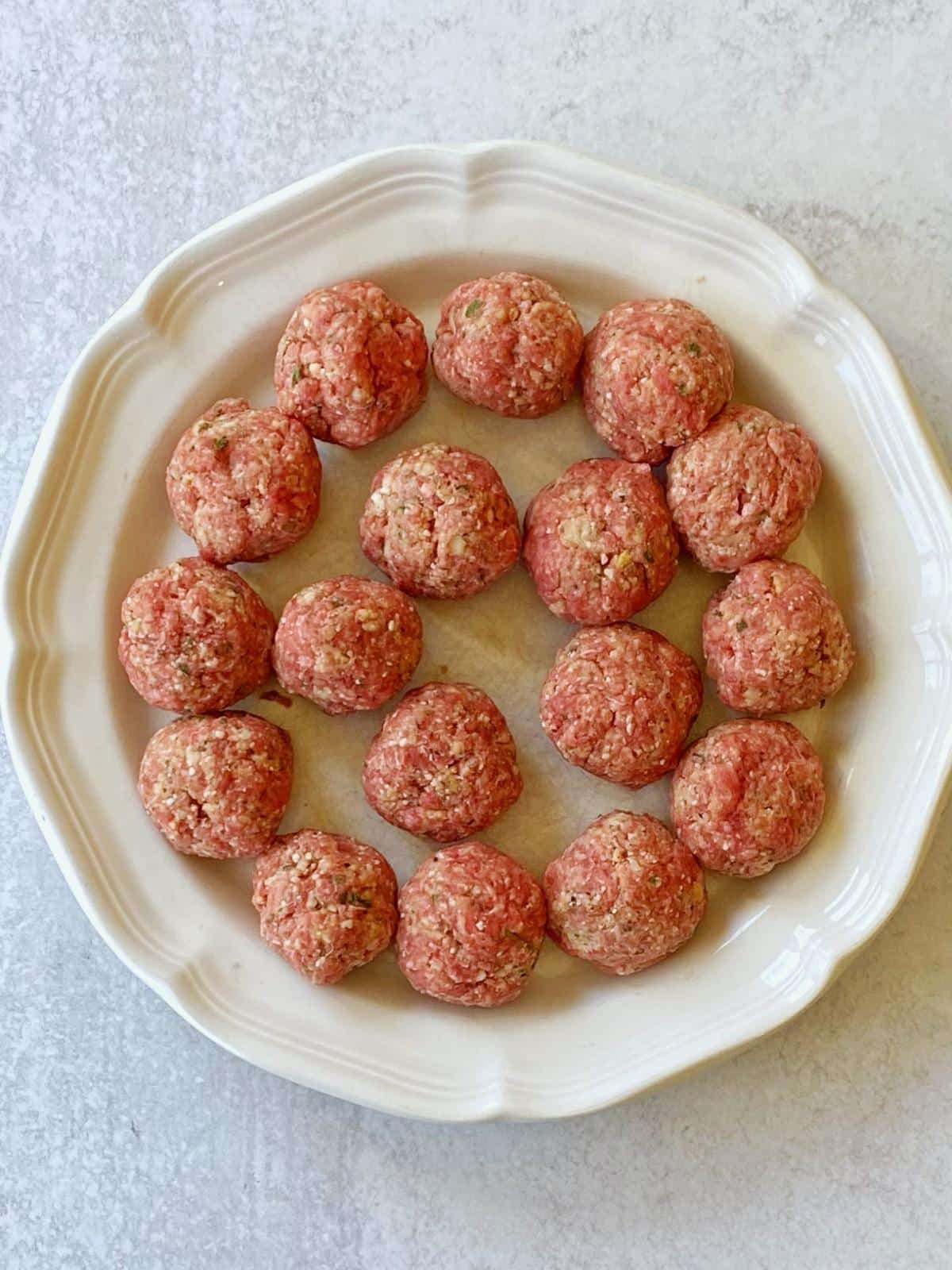 Formed meatballs on a plate.