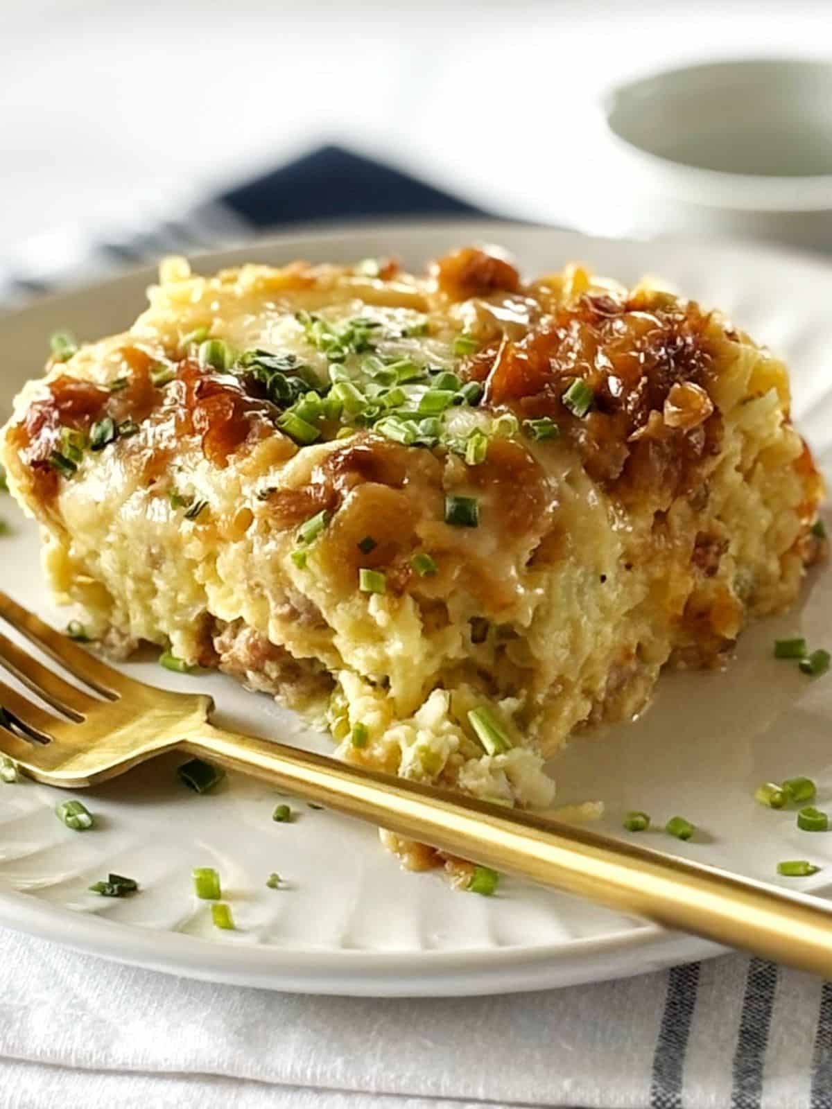 Slice of casserole on a plate with a fork.