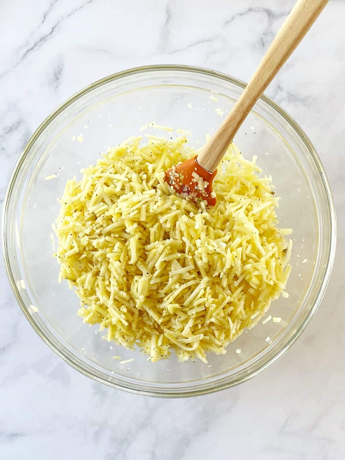 Shredded potatoes mixed with melted butter and seasonings.