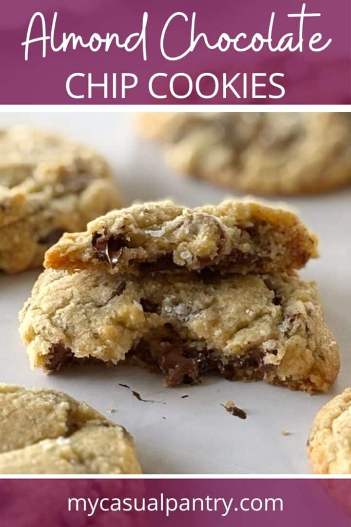 Baked cookie broken in half with melted chocolate center.