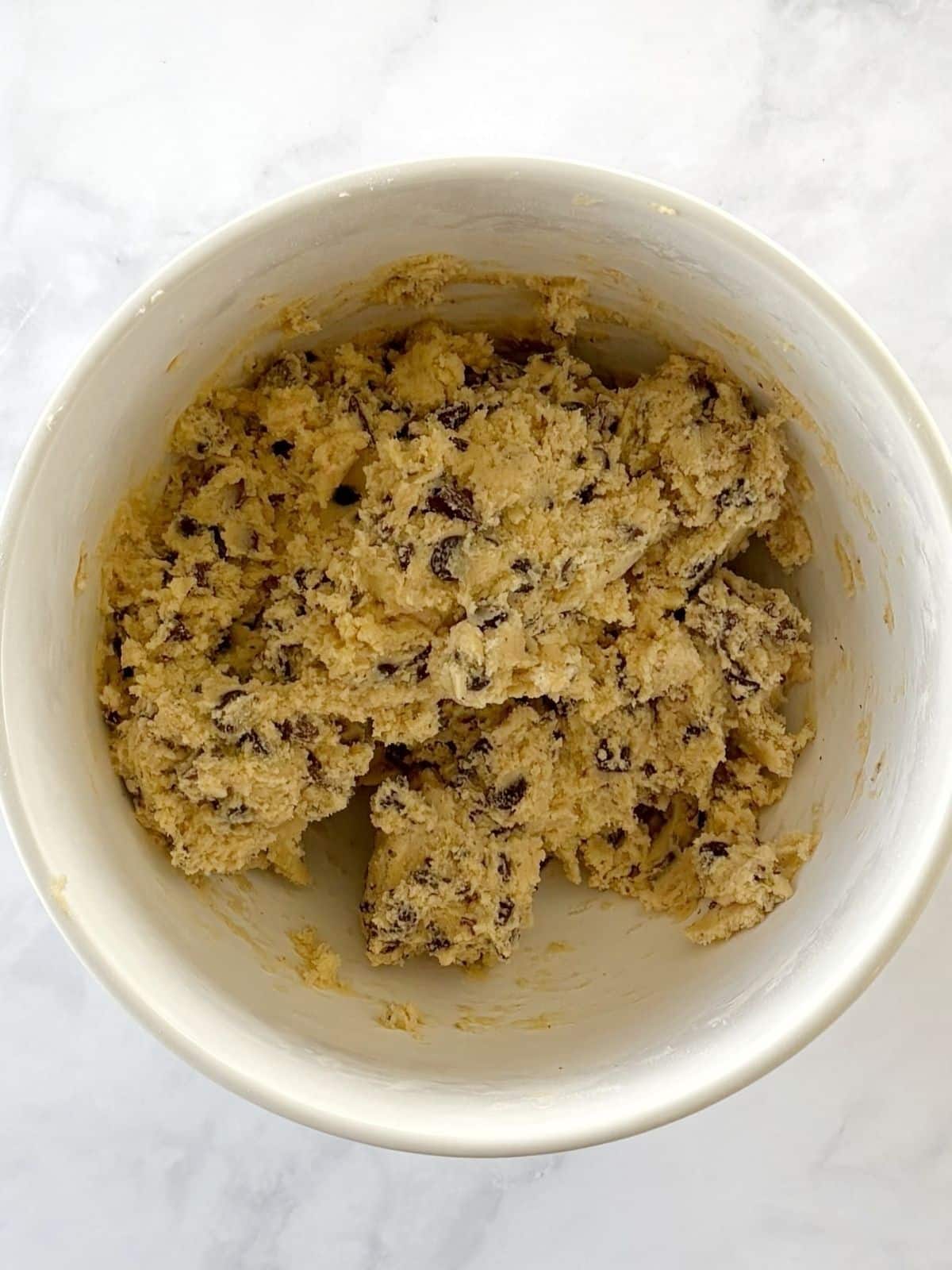 Chocolate chip cookie dough in a mixing bowl.