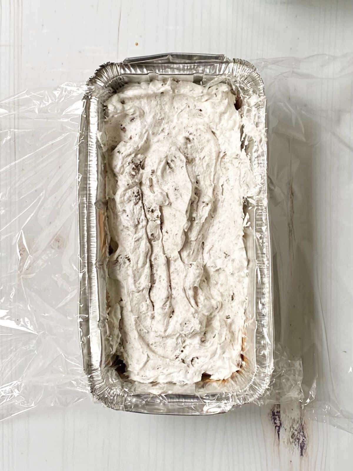 Layering cake with whipped cream.