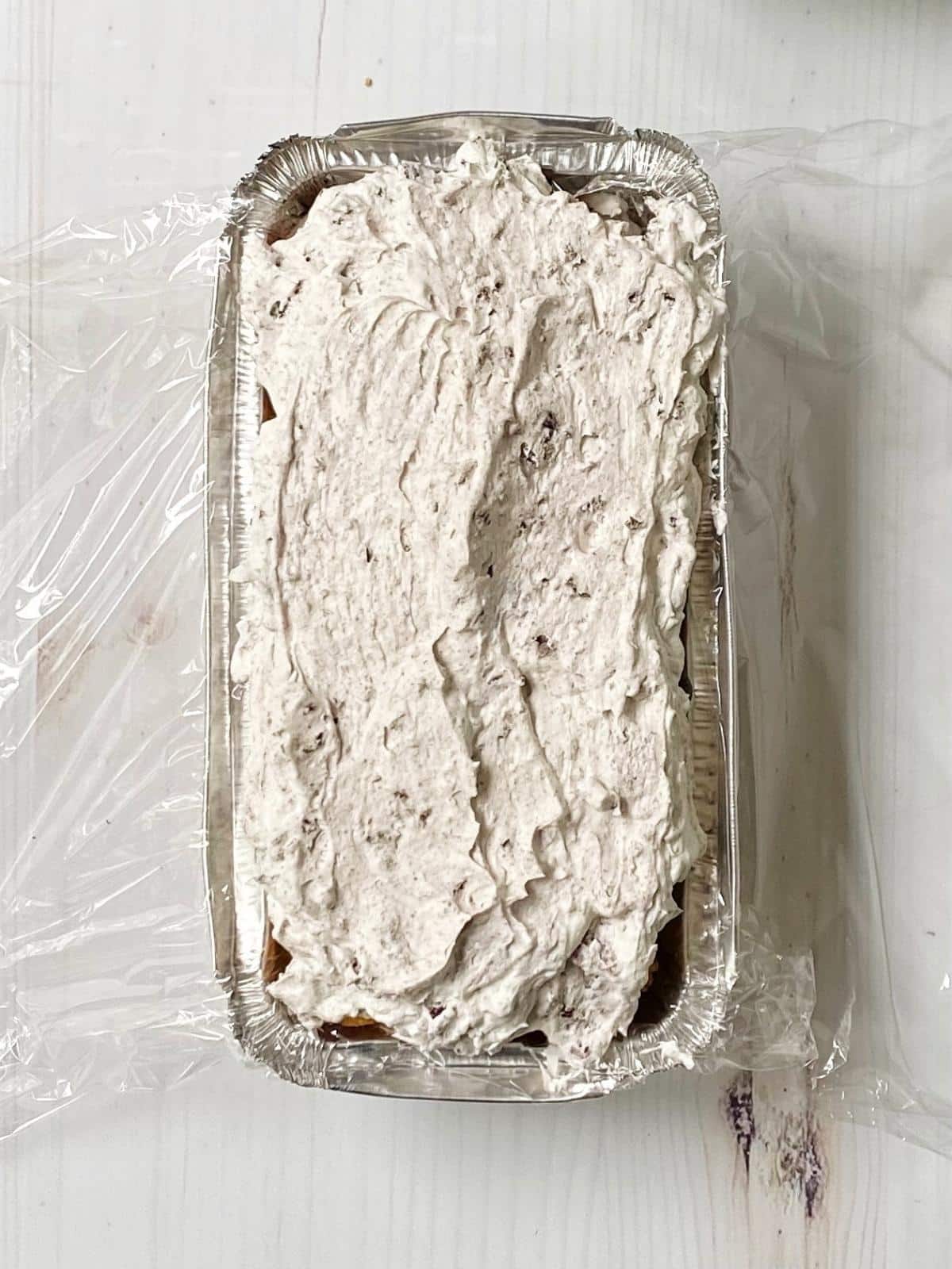 Cake pan with second layer of whipped cream.