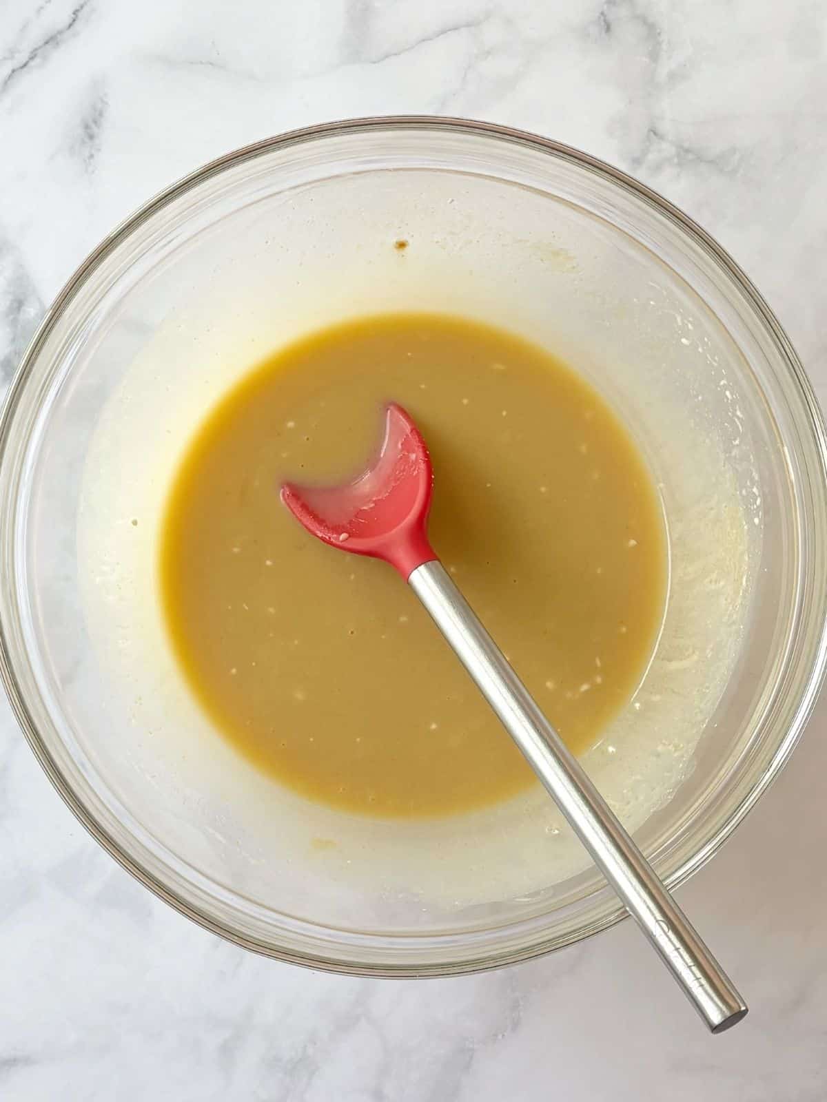 Sour cream and milk added to sugar, butter, and egg mixture.