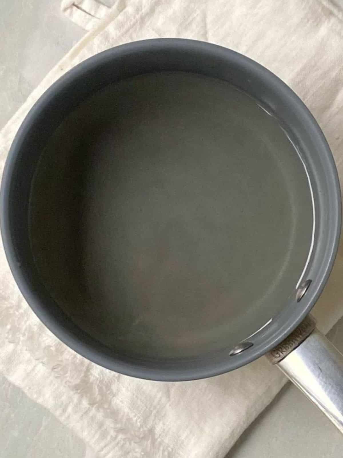 Sugar and water dissolved in a saucepan.