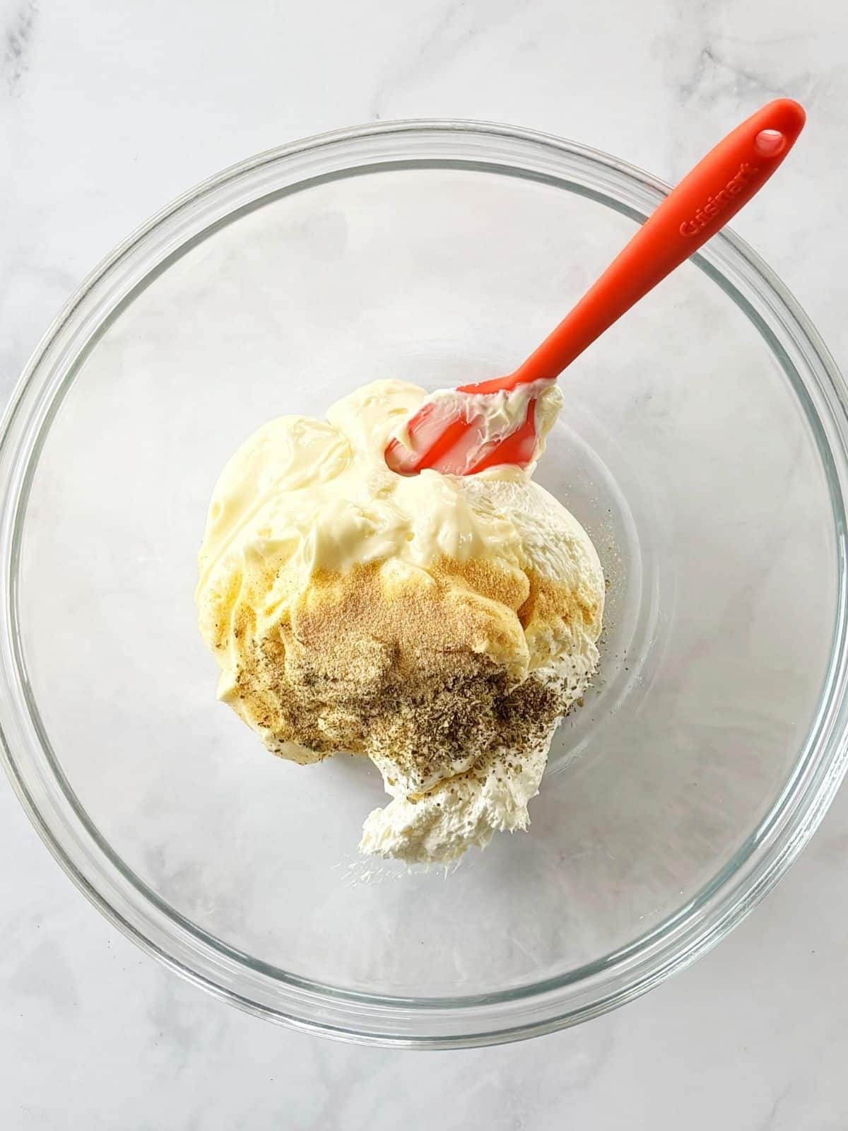 Cream cheese, mayonnaise, and seasonings in a mixing bowl.
