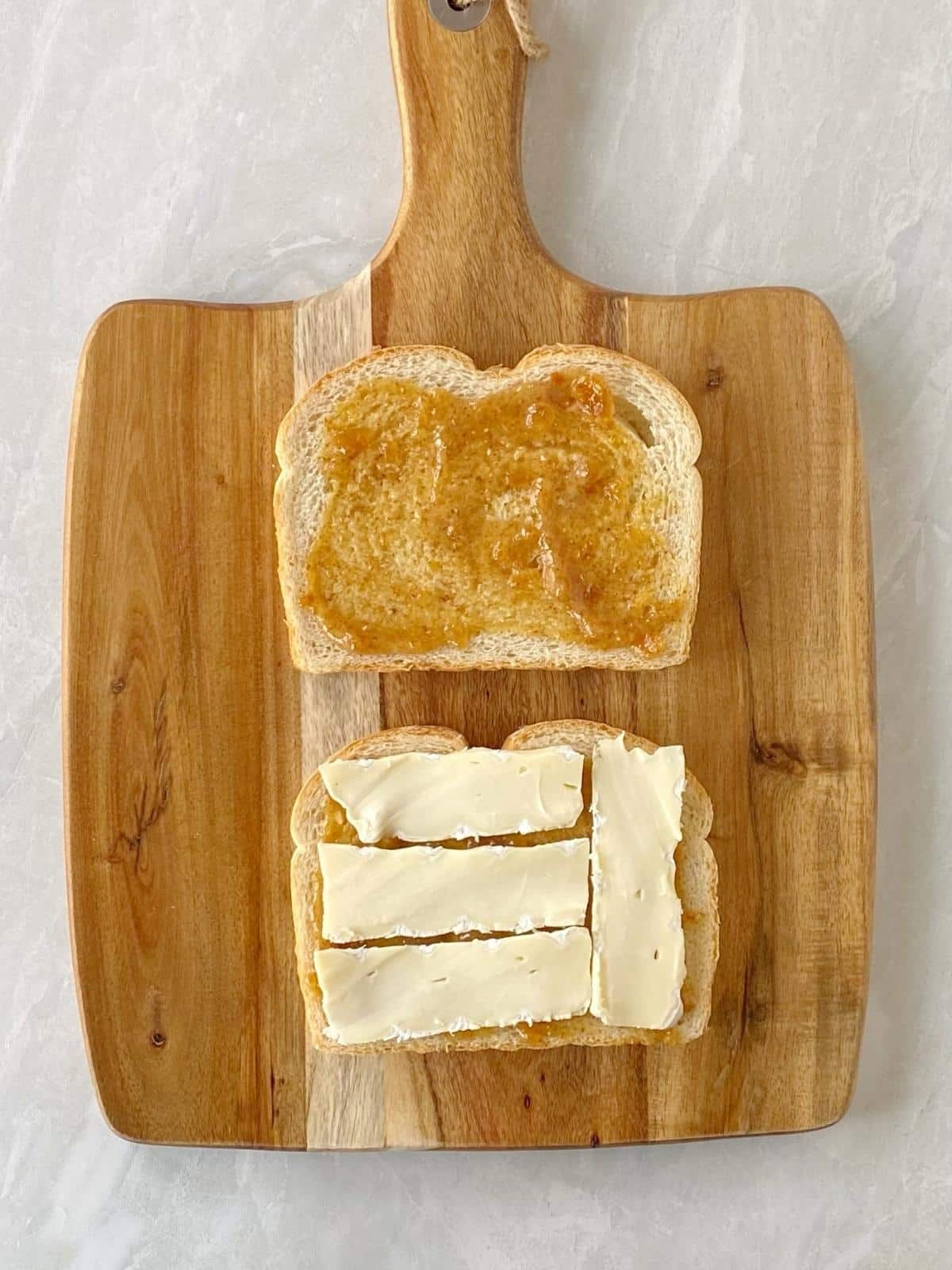Bread spread with fig jam and mustard and topped with slices of Brie.