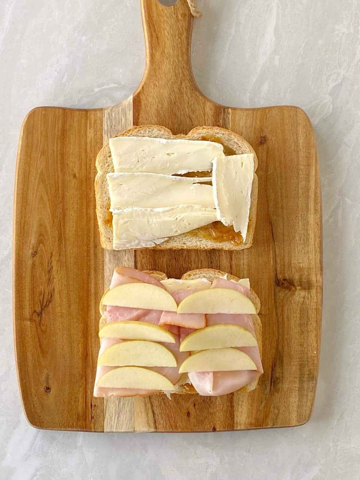 Apple slices and more Brie layered onto the sandwich.