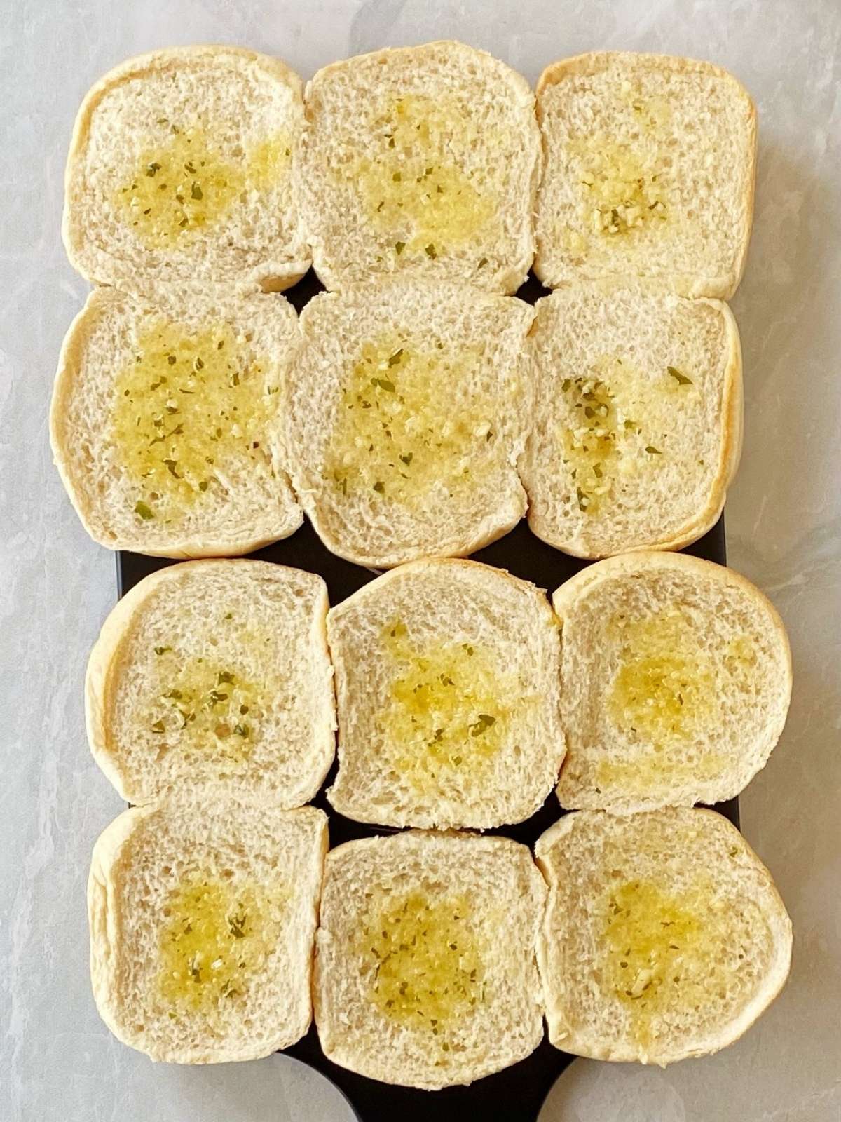 Top half of buns brushed with butter on the inside.