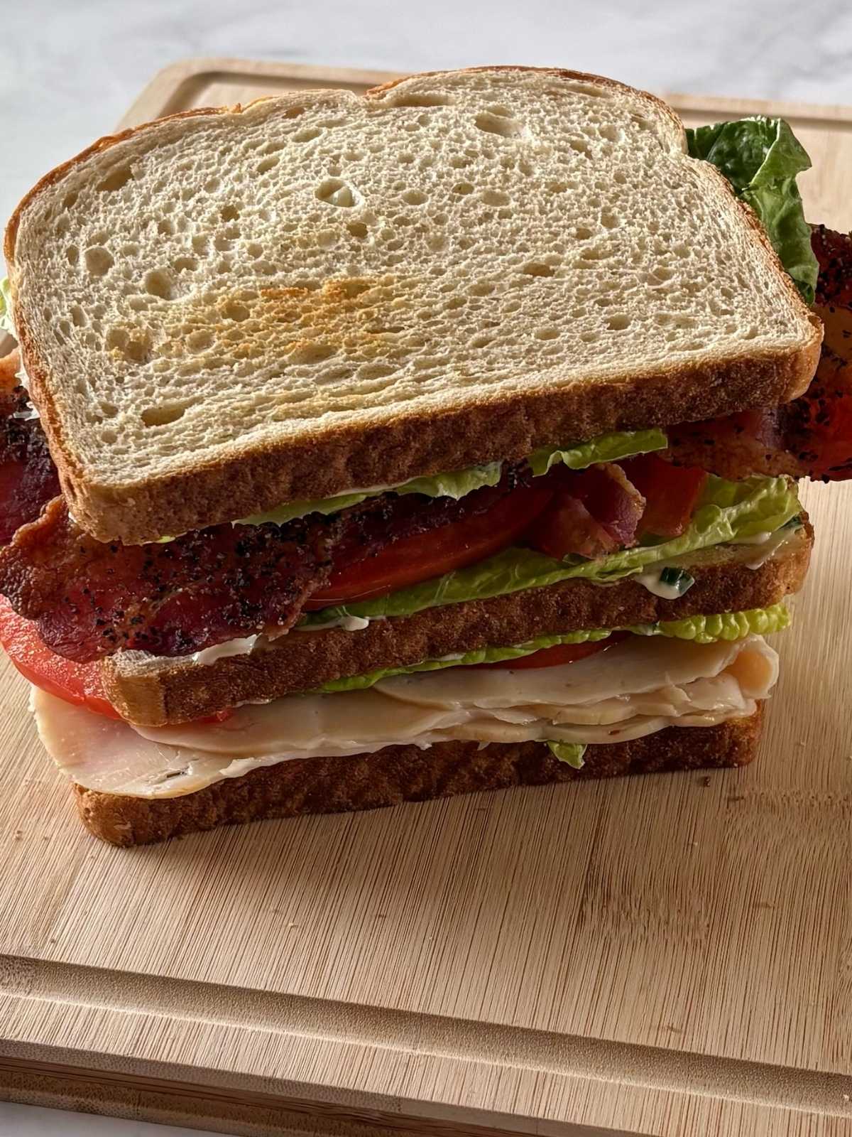 The fully assembled sandwich on a cutting board.
