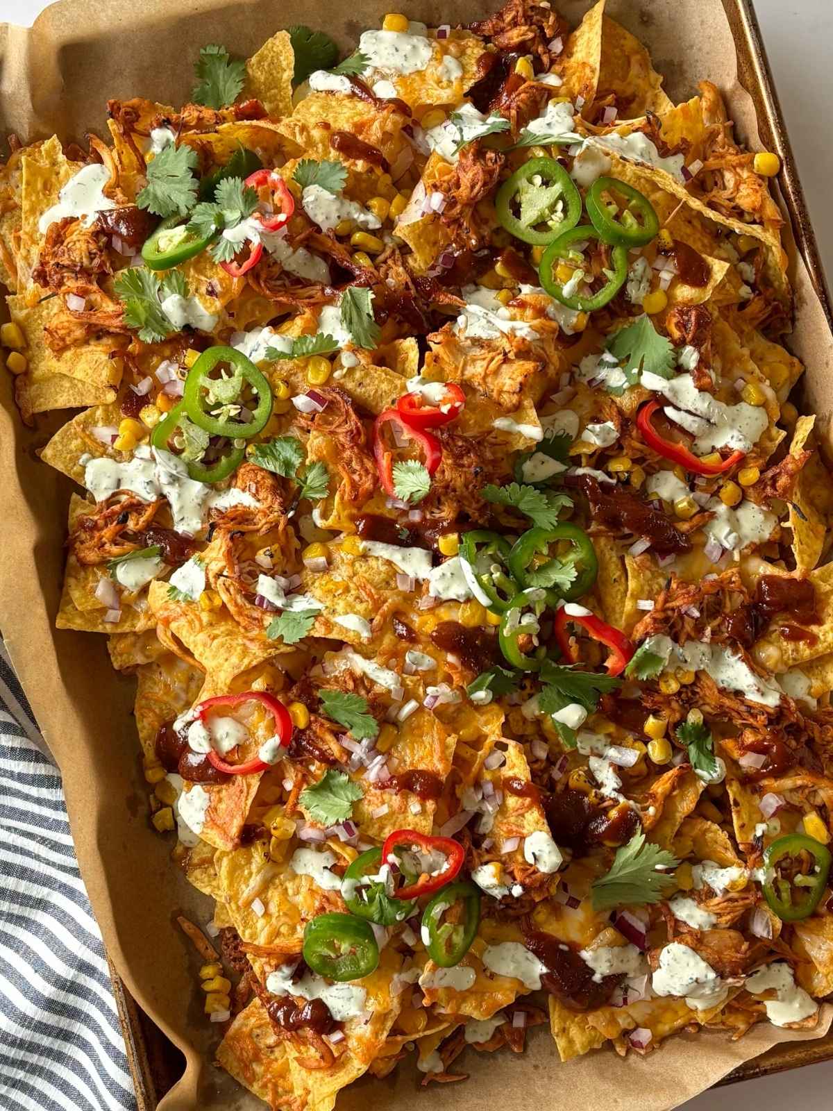 Sheet pan of barbecue chicken nachos.