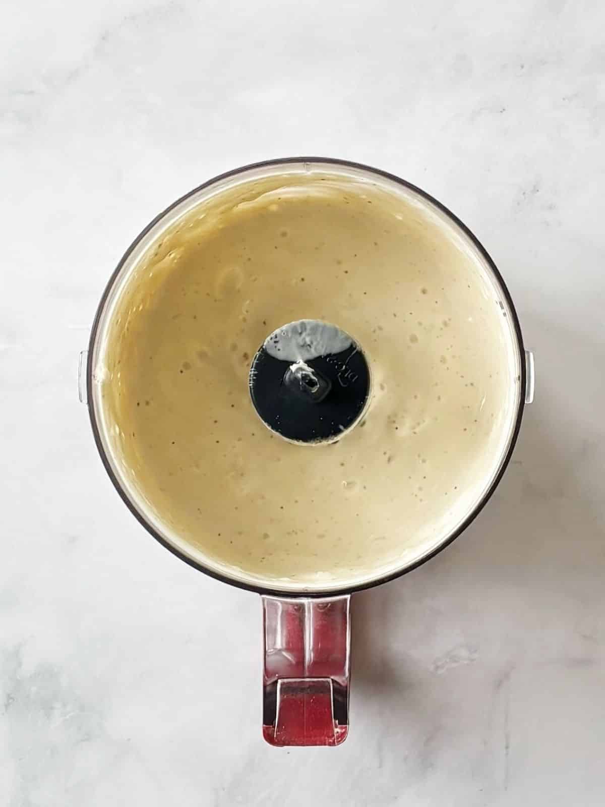 Blending blue cheese dressing in a food processor.