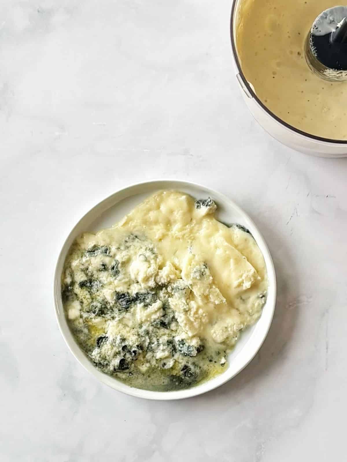 Warmed blue cheese on a plate.