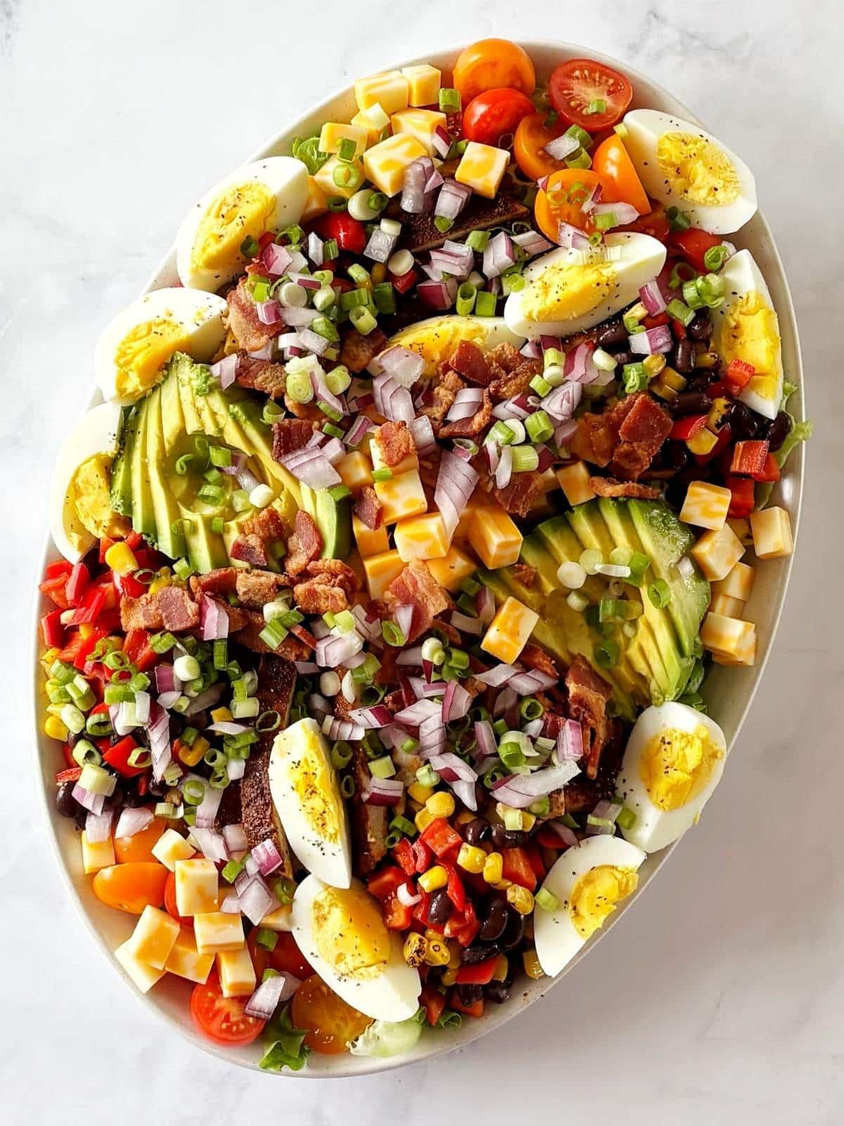 Mexican Cobb salad ingredients arranged on a platter.