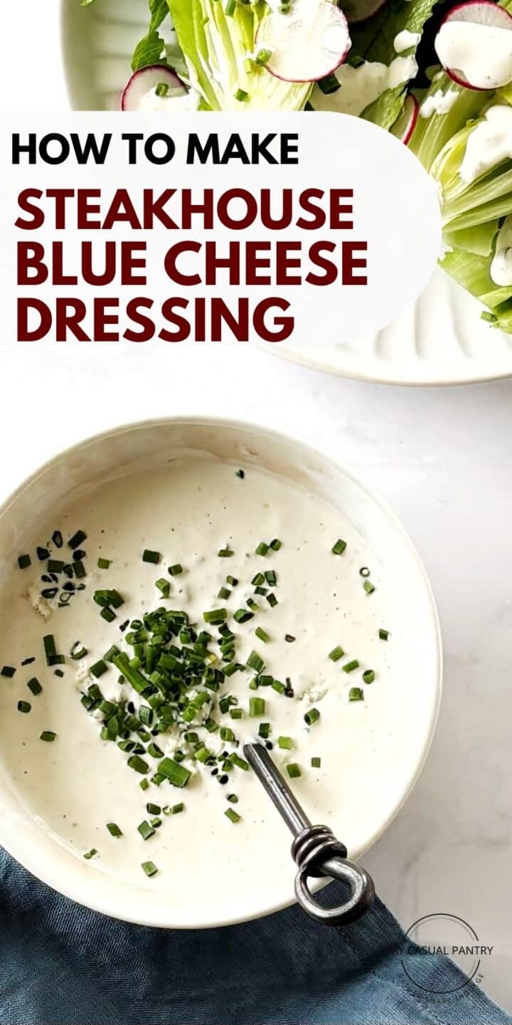A dish of blue cheese dressing next to a plate of salad.