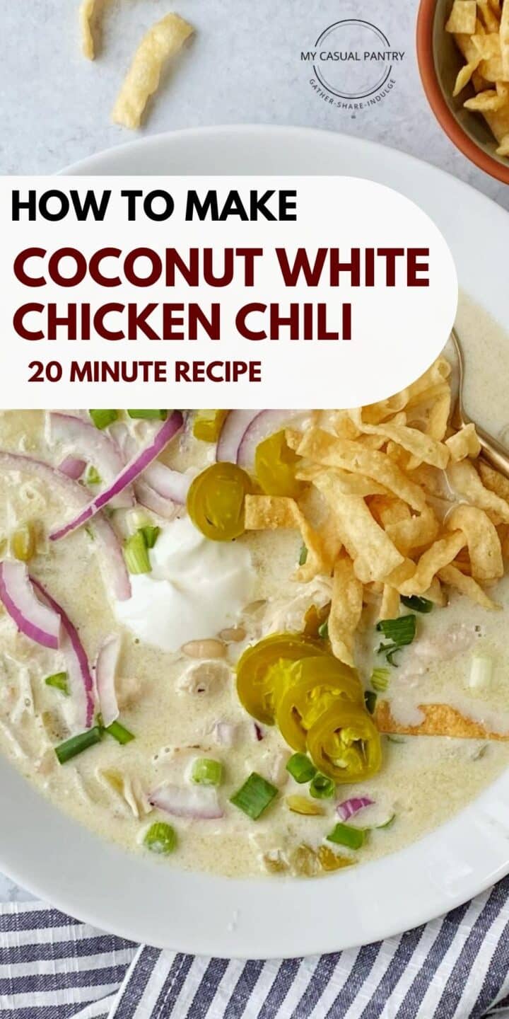 A bowl of coconut chicken chili topped with garnishes.